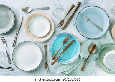 Modern Tableware Set With Cutlery And A Vibrant Blue Plate, Overhead Flat Lay Shot