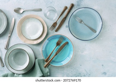 Modern Tableware Set With Cutlery And A Vibrant Blue Plate, Overhead Flat Lay Shot With Copy Space