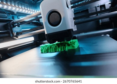 In a modern tech workshop, a 3D printer operates, meticulously crafting a vivid green object. The intricate design takes shape layer by layer, showcasing advanced printing technology.