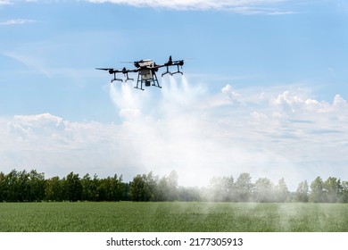Modern technologies in agriculture. industrial drone flies over a green field and sprays useful pesticides to increase productivity and destroys harmful insects. increase productivity - Shutterstock ID 2177305913