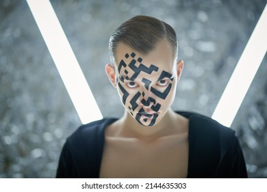 Modern technologies of human personification. Portrait of a young man with a QR-code painted on his face, who stands in front of futuristic neon lamps and looks at the camera aggressively. 