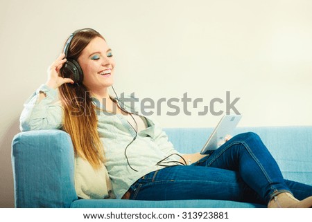 Similar – Happy woman listening to music wearing headphones