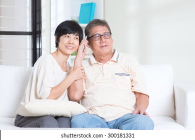 Modern Technology, Age And People Concept. Mature Asian Couple Using Smart Phone. Family Living Lifestyle At Home.