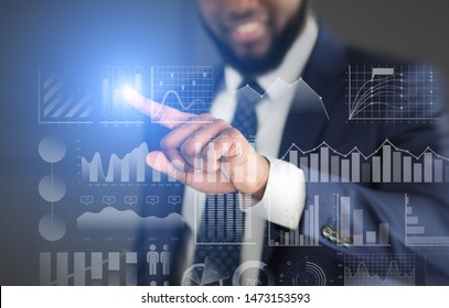 Modern technology. Businessman choosing with finger analytic diagram with data on transparent screen - Powered by Shutterstock