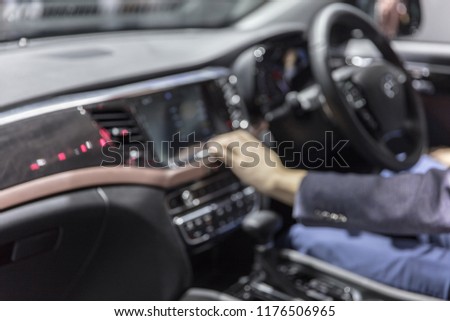 Modern technology, mass media and people concept - male hand pointing finger to monitor on car panel