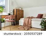 Modern teenage room interior design with bed, table, chest of drawers, pink velvet chair and personal accessories. Template.
