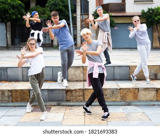 Modern teenage street dancers performing outside in summer. Urban lifestyle .