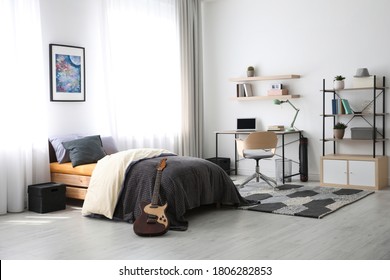 Modern teenager's room interior with workplace and bed - Shutterstock ID 1806282853