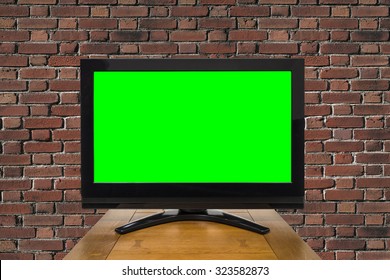 Modern Television With Chroma Key Green Screen And Red Brick Wall.