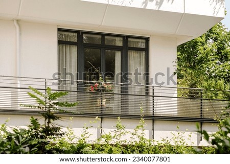 Modern Terrace Balcony of Modern White Residential House or Hotel with Balcony Railing Outside. Comfortable Balcony Outdoor with Green Landscape Around.