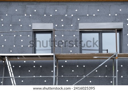 modern thermal insulation materials. building New House in process insulation of the wall of the house with layers Exterior covering in construction site.