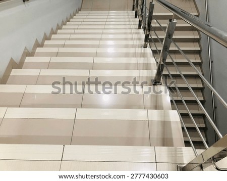 Modern tiled staircase with geometric pattern and perspective lines. 