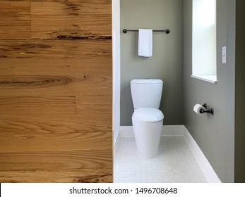 Modern Toilet Design With Clean Lines In Stylish Small Bathroom With Sliding Barn Door