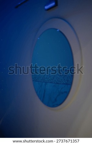 A modern, touchless, dark room floatation bath.A closed-surface spa capsule with touchscreen controls in a room with soft lighting