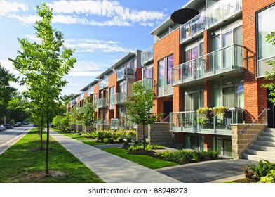 Modern town houses of brick and glass on urban street