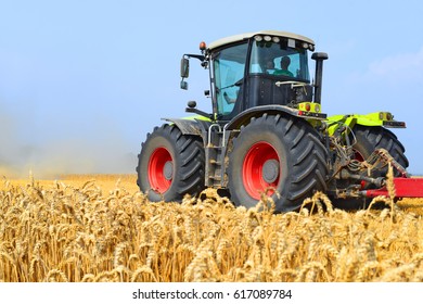 Modern tractor on field works - Shutterstock ID 617089784