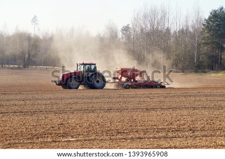 A modern tractor produces seeding with a multifunctional seeder