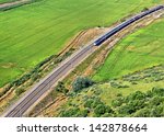 Modern train passing through green country landscape