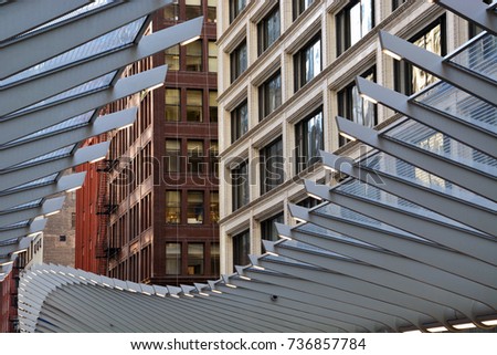 A modern train platform canopy opens like a zipper to the cityscape canyon of vintage turn of the century lofts in Chicago's downtown business district.