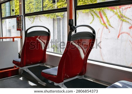 Modern tram interior with empty seats and view through windows