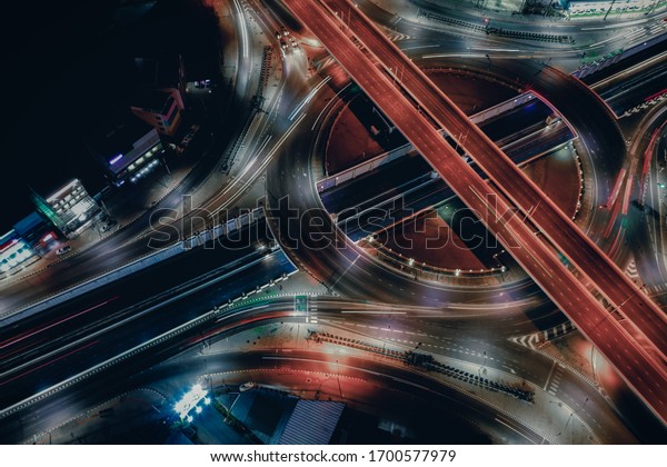 Modern transportation, smart transport with\
Expressway, Road, Roundabout, multilevel junction highway in\
business area -Top view. Car movement at night Important\
infrastructure. Transport\
technology.