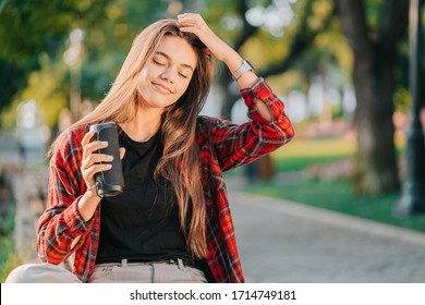 Modern Trendy Girl Listening To Music By Wireless Portable Speaker.Young Beautiful American Woman Enjoying,dancing In Park.