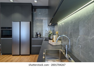 Modern Trendy Luxury Dark Gray Kitchen Closeup To Worktop With Marble Wall