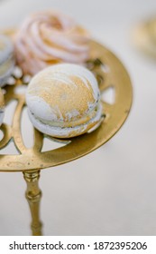 Modern Trendy Macaroon Dessert On A Gold Stand Close Up