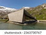 Modern triangle building of Trollstigen cafe and visitor center in front of the mountains. Norway