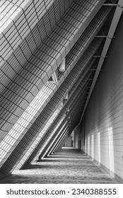 Modern triangular structure in black and white with shadows that enhance the straight lines of the asymmetric construction.