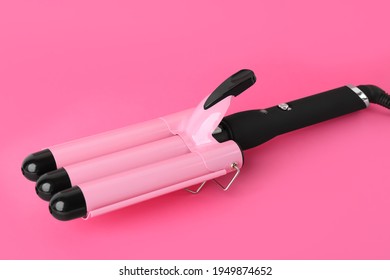 Modern Triple Curling Iron On Pink Background