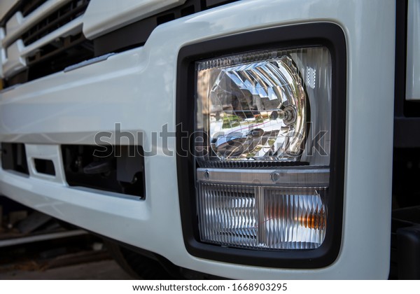 Modern truck headlight with diode\
illumination. Road safety concept, close-up.\
LED