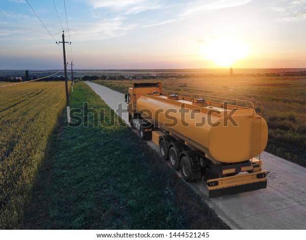 Modern truck on\
country road. Space for\
text