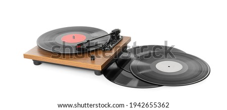 Modern turntable with vinyl records on white background