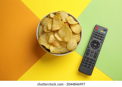 Modern Tv Remote Control And Chips On Color Background, Flat Lay