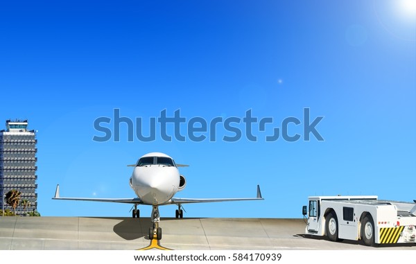 Modern twin jet engine business corporate\
private executive luxury jet airplane parked on runway at airport\
with aircraft parts gear wings aircraft pushback tug truck aerial\
view aviation background