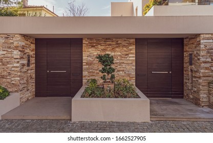 Modern Two Family House Stone Wall Entrance With Solid Wood Doors By The Sidewalk