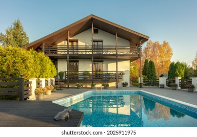 Modern Two Storey Country House With Outdoor Pool And Beautiful Garden. Sunset Light. Space For Text