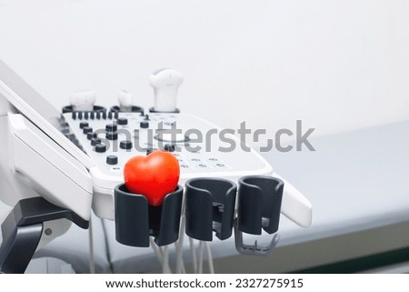 Modern ultrasound machine, scanners and sensors close-up. Medical equipment in the clinic with a red heart. Ultrasound scanning diagnostic. health care and medicine concept.