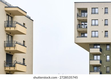 Modern urban architecture featuring angular apartment buildings with balconies.