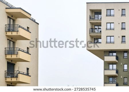 Modern urban architecture featuring angular apartment buildings with balconies.