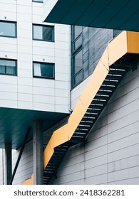 Modern Urban Architecture Featuring Geometric Shapes and Vibrant Yellow Staircase