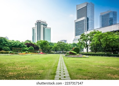 Modern urban business buildings behind lawn