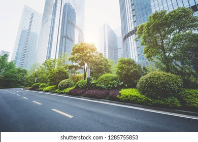 Modern Urban Commercial Buildings And Asphalt Roads.