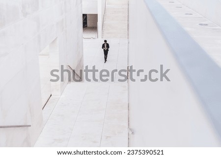 Modern urban underpass and man walking along in distance
