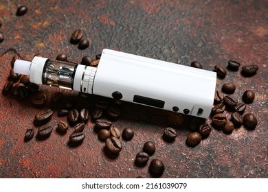 Modern vape mod and coffee beans on color background, closeup