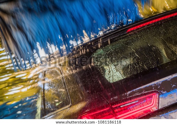 Modern Vehicle in the Car Wash Closeup Photo.\
Automatic Brush Washer.