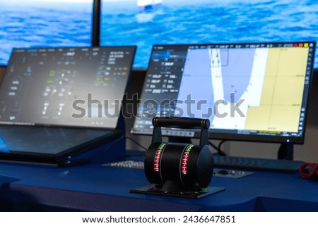 Modern vessel control panel with the engine accelerator and digital screens, close up photo with selective focus. Electronic equipment of marine navigation simulation system,