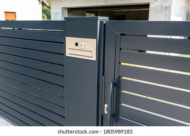 A modern videophone with a letterbox and a wireless card reader, mounted in panel fence in anthracite color, visible wicket. - Shutterstock ID 1805989183