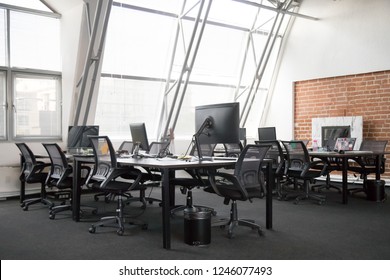 Modern View Of Empty Office Space Interior, Open Plan Office Concept, Trendy Loft Workspace With Big Windows, Lot Of Office Equipment, Computers, Monitors, Natural Light, Creativity, Without People